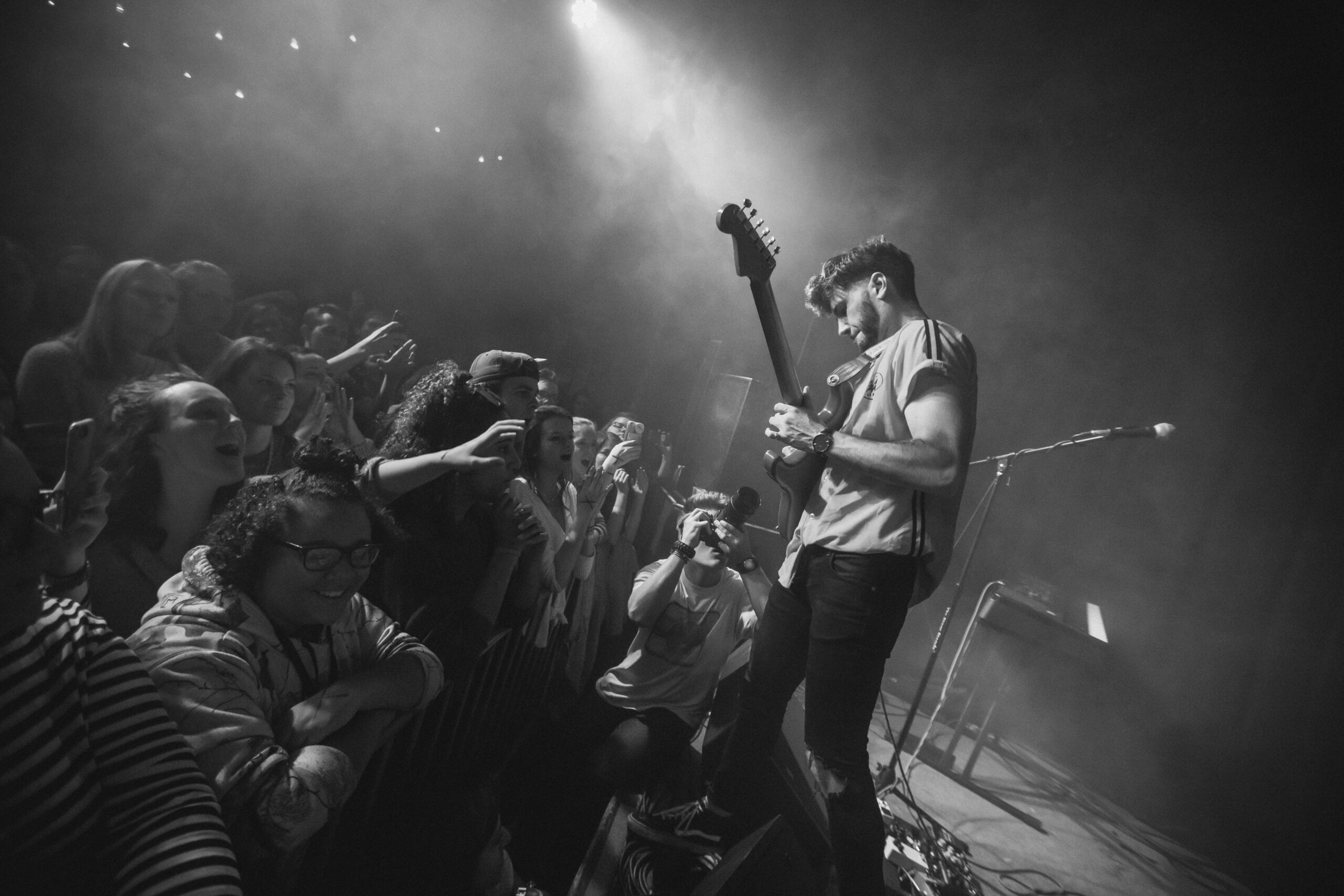 Electric guitarist playing in front of a live audience 