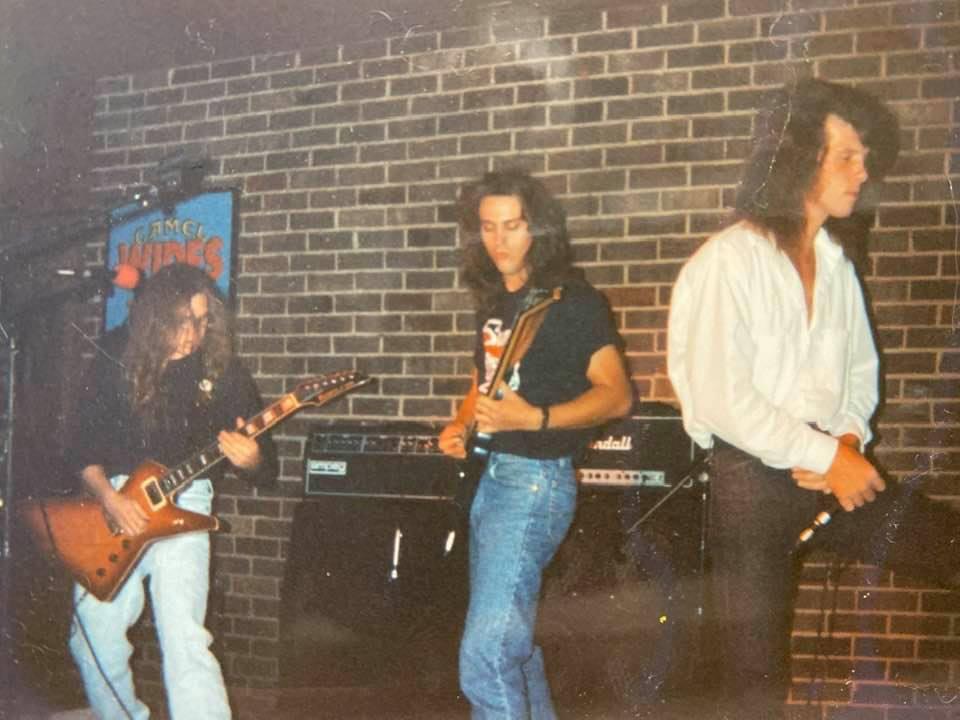 Young rock band playing live on stage