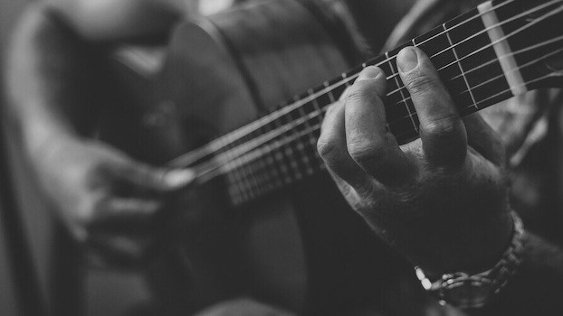 strumming a guitar