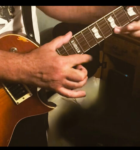 String Shock Steve playing guitar