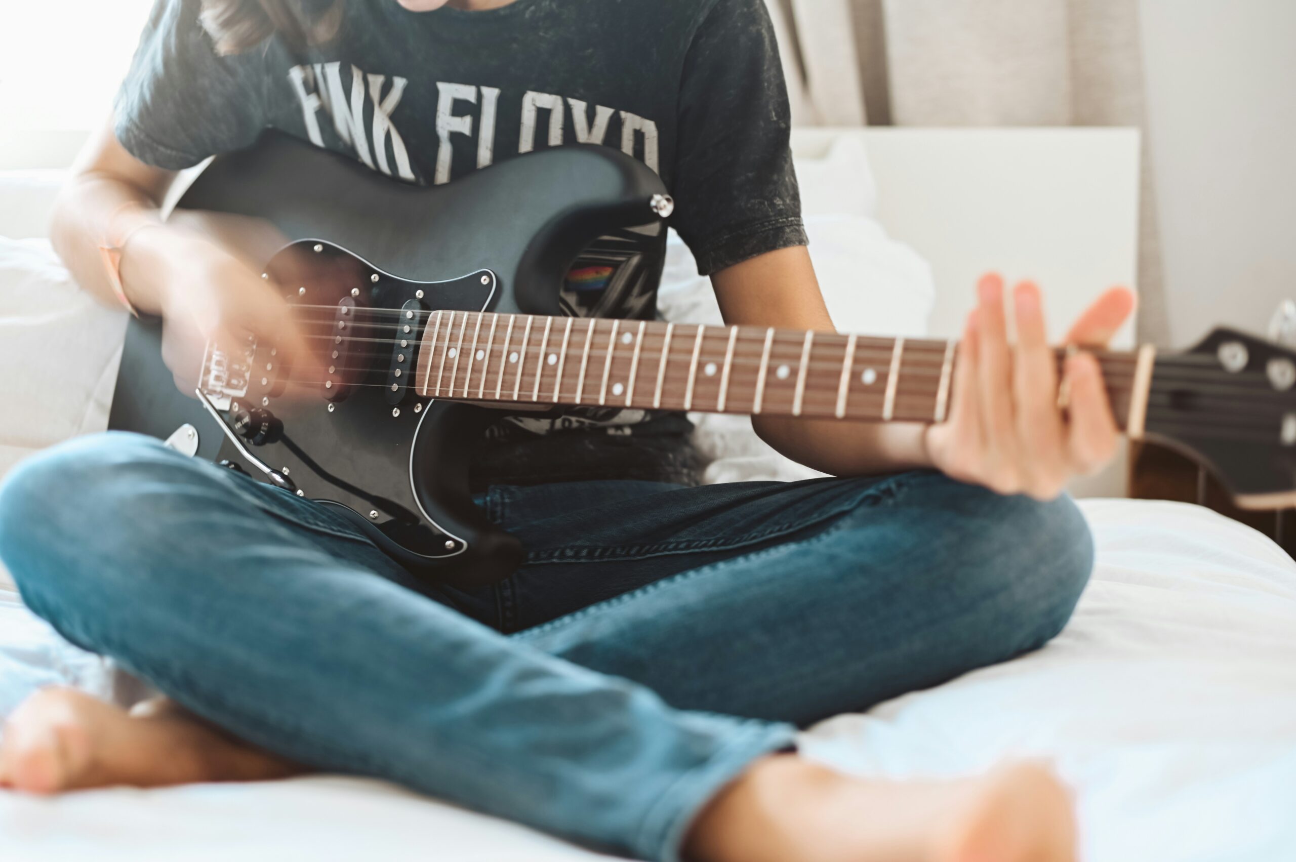 Guitarist sliding down a guitar string