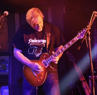 Steve Accardo playing an Ltd ec-256 guitar wearing a Stonehenge t-shirt