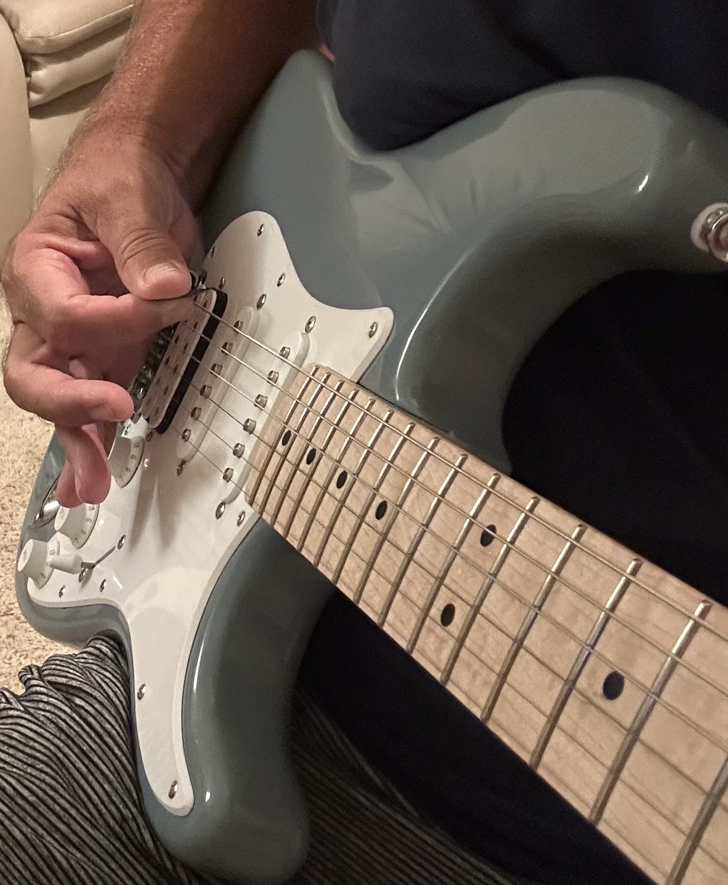 Close-up of hand position for proper palm-muting technique